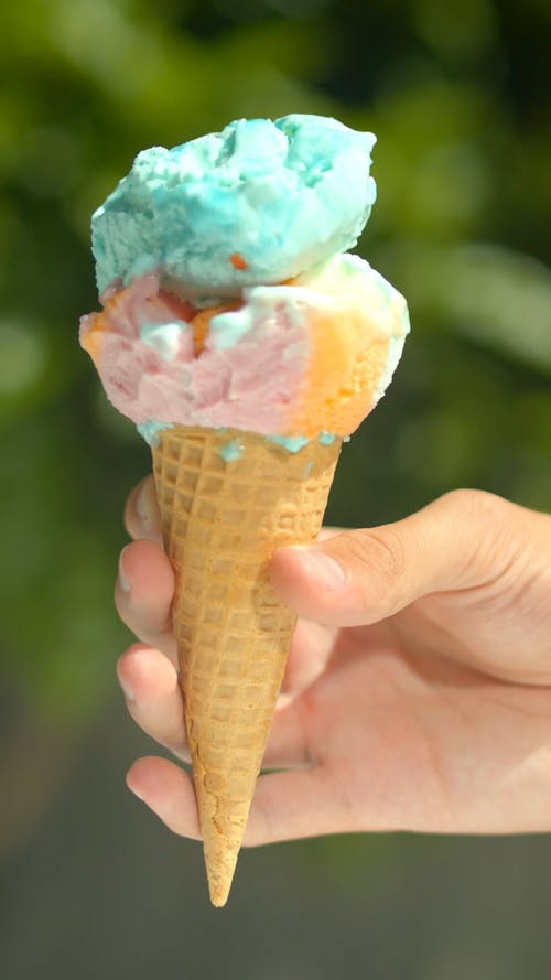 Person Holding the Ice Cream on the Cone