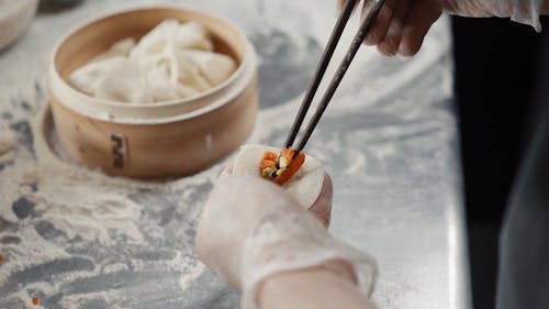 Person Preparing A Dumpling