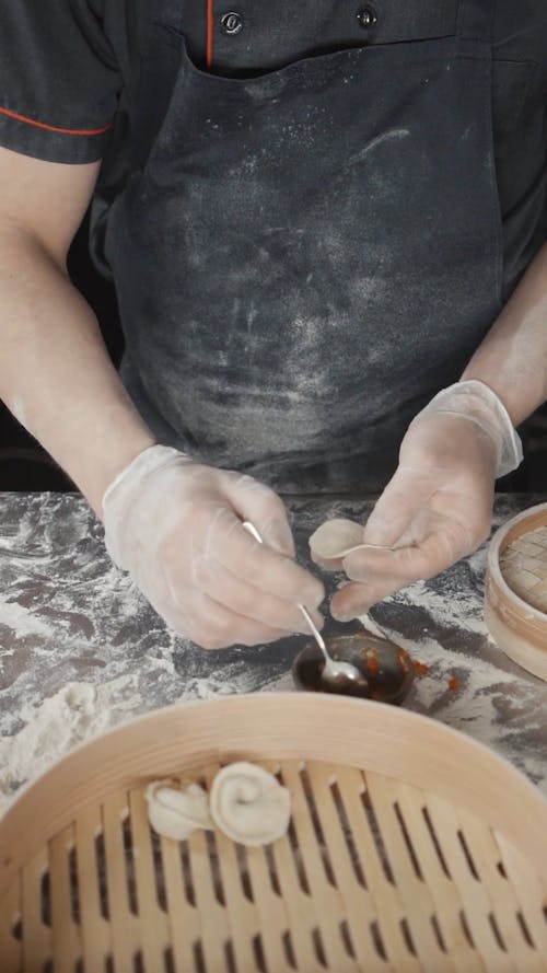 Person Preparing A Dumpling