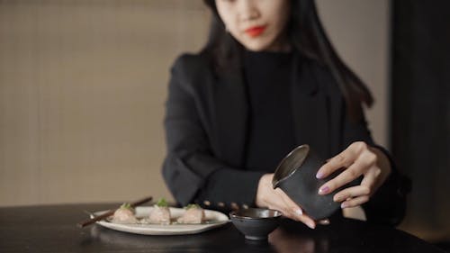 Woman Pouring Sauce on a Saucer