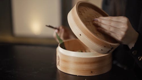 Woman Eating A Dumpling