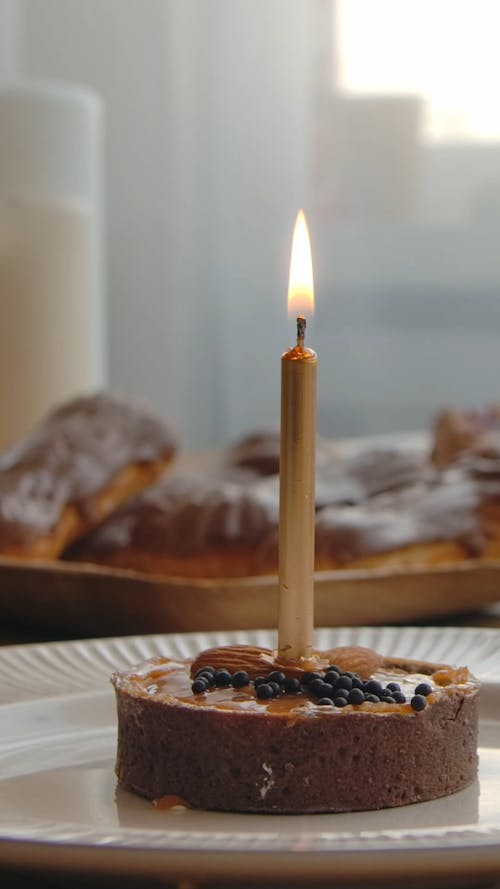 A Birthday Cake with Lighted Candle   