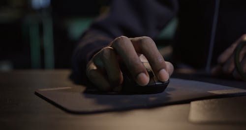 Person Drinking Tea while Typing on Keyboard