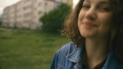 Young Woman Walking While Smiles On Camera