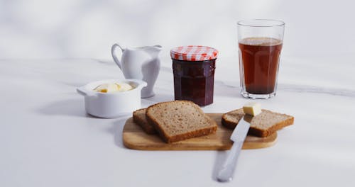 Person Pouring Milk on Tea