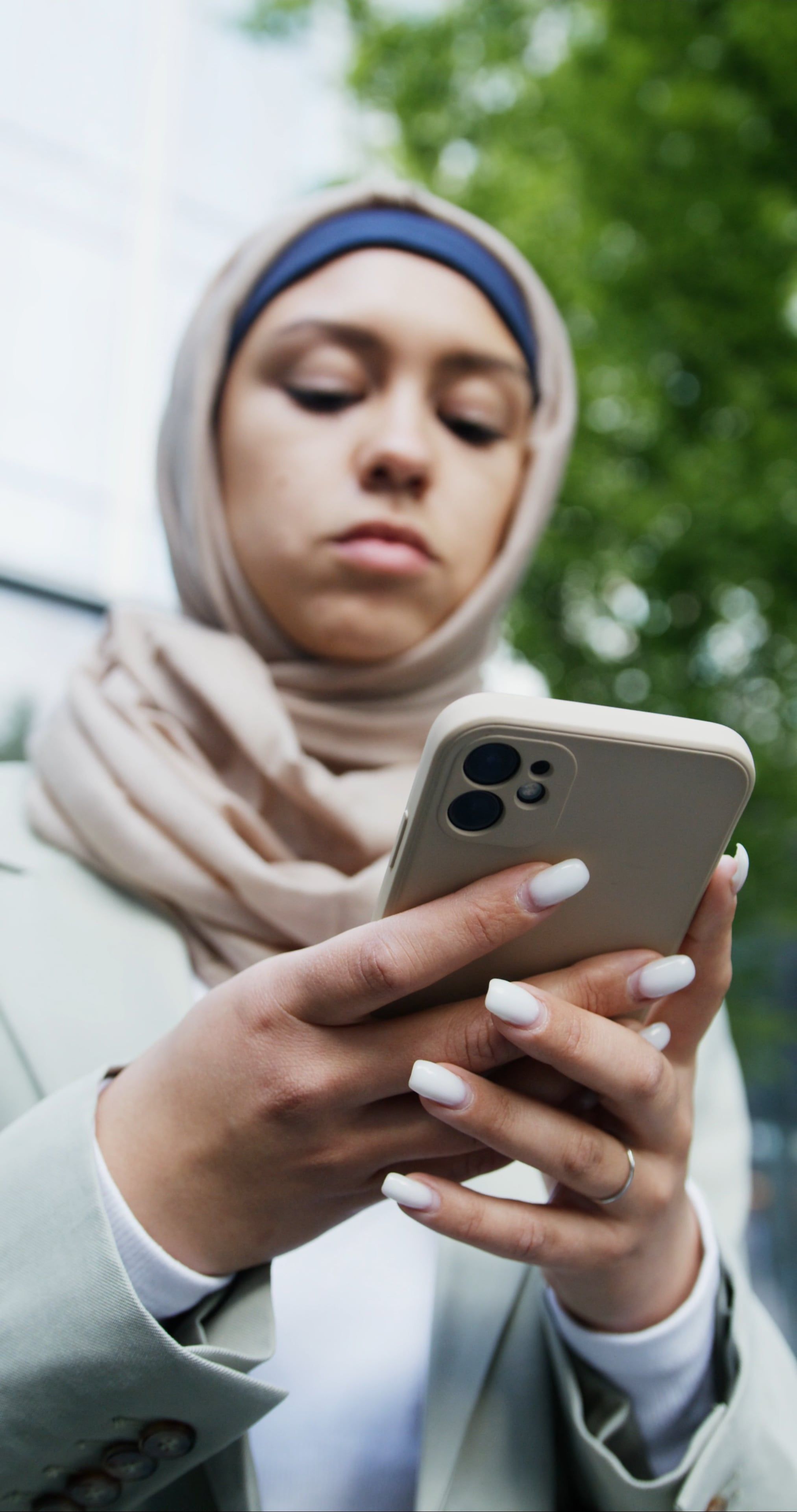A Woman Wearing Hijab while Using Her Mobile Phone Free Stock Video ...