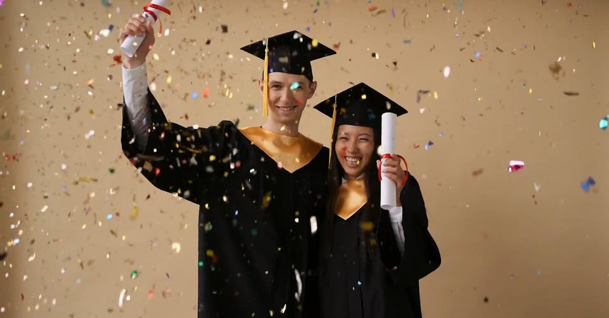 Young Graduates In Their Graduation Gowns Happily Celebrating Success ...
