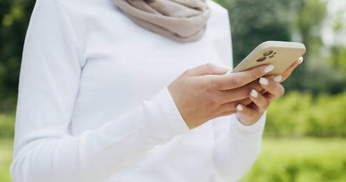 Woman Using Cellphone While Walking