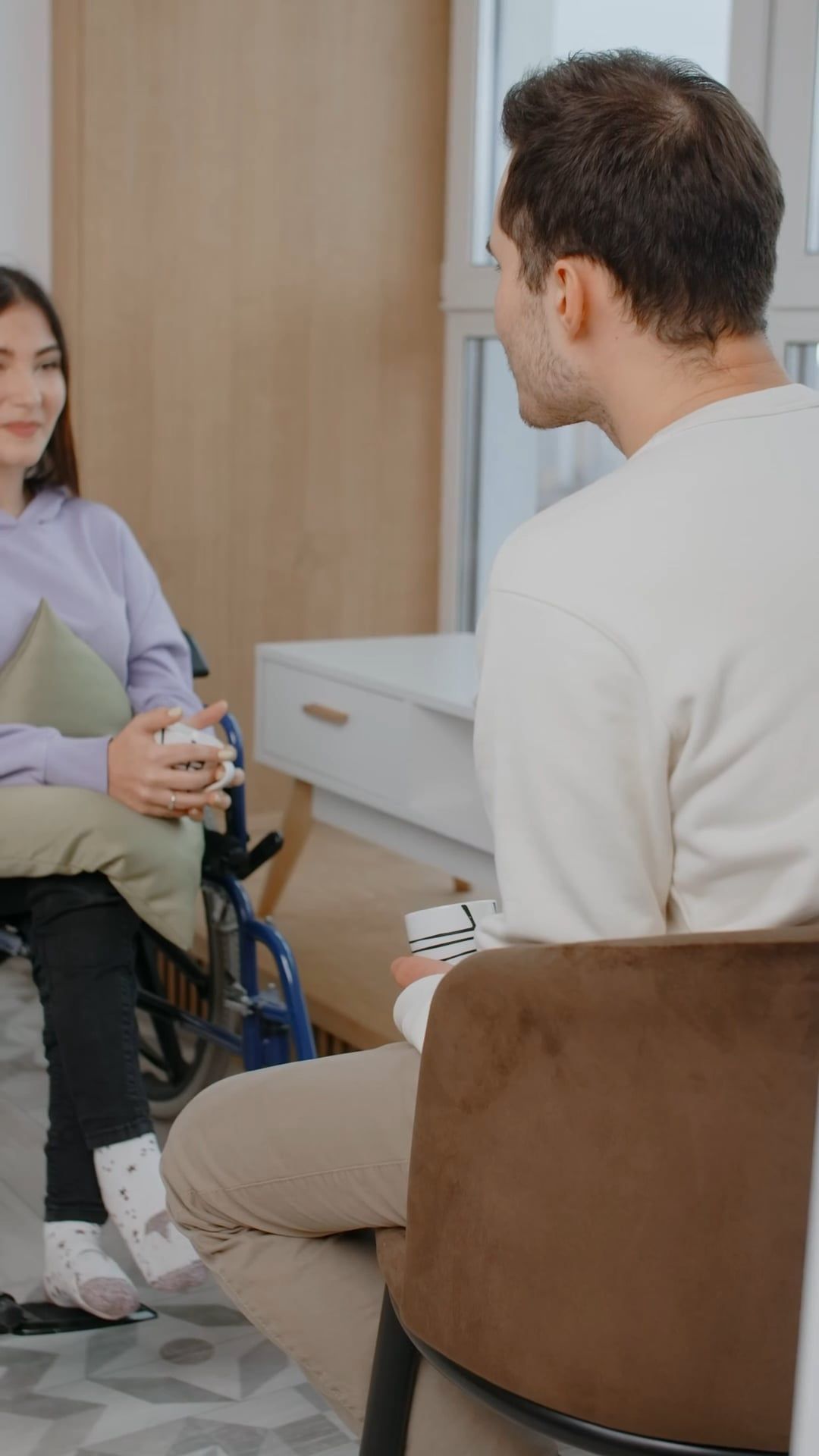 A Woman in Wheelchair is Talking and Smiling to a Man in Front of Her ...