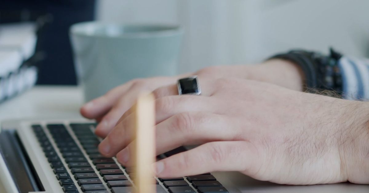 A Person Typing on the Laptop While Another Person is Writing on a ...