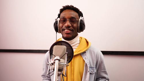 A Man Recording a Song Using a Phonograph