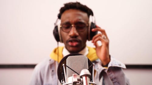 A Man Recording a Song on a Phonograph