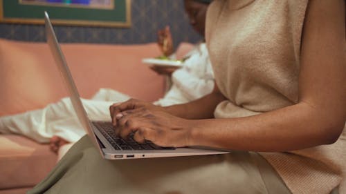 Side View Of Woman Typing On Laptop