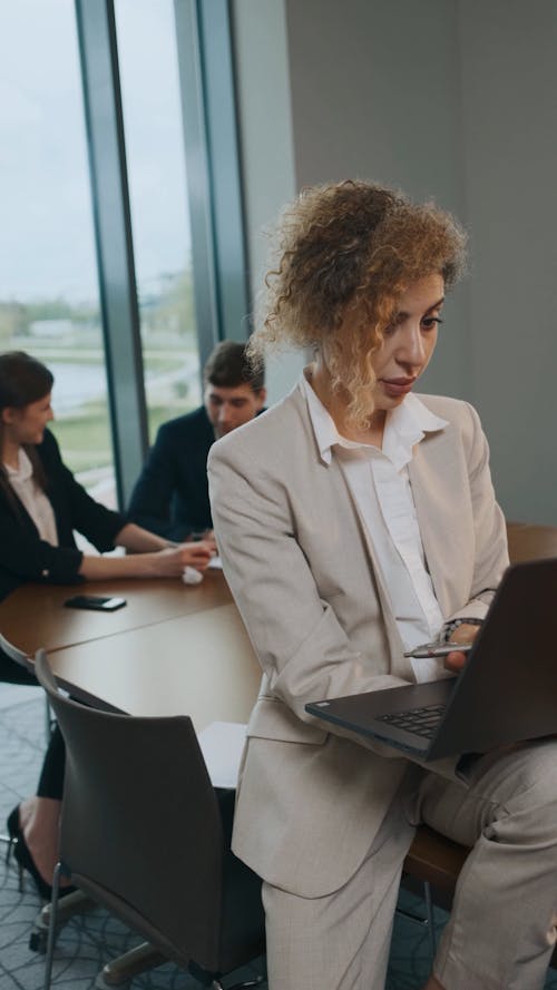 A Woman Using a Laptop at an Office