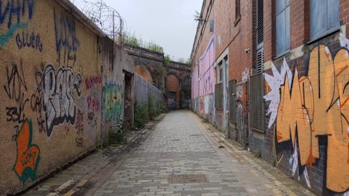 An Alleyway Full Of Graffiti Art On Wall Free Stock Video