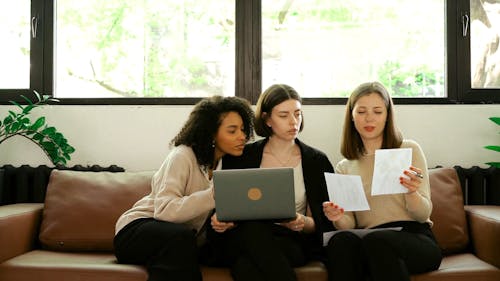 Women Talking while Looking at the Photos