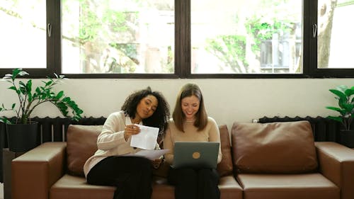 Women Sitting on the Sofa while Talking