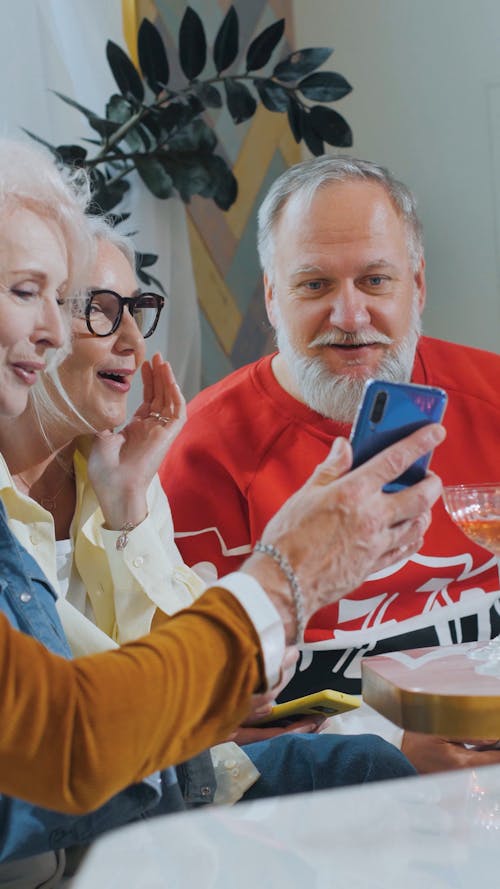 Elderly People Looing at the Screen of a Cellphone