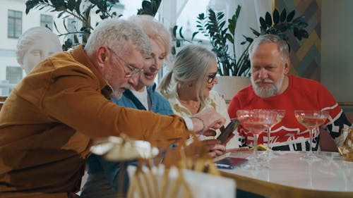 Old Friends Having Fun while using Smartphone