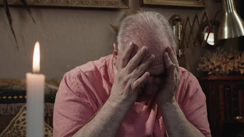 An Upset Elderly Man Hands on his Head