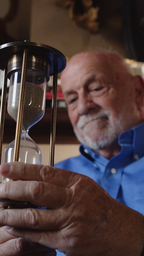 Elderly Man Holding an Hourglass