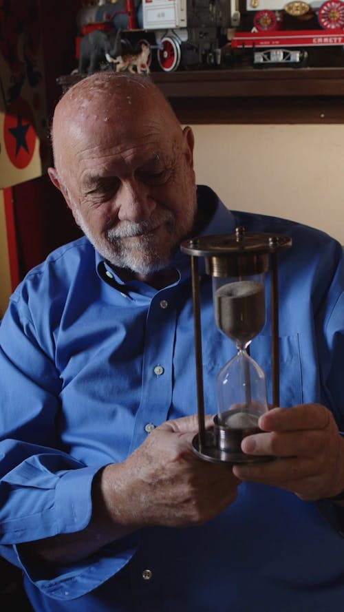 Elderly Man Holding an Hourglass