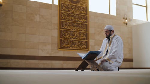 A Man Reading a Quran in a Mosque