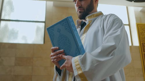 Man Hugging a Quran