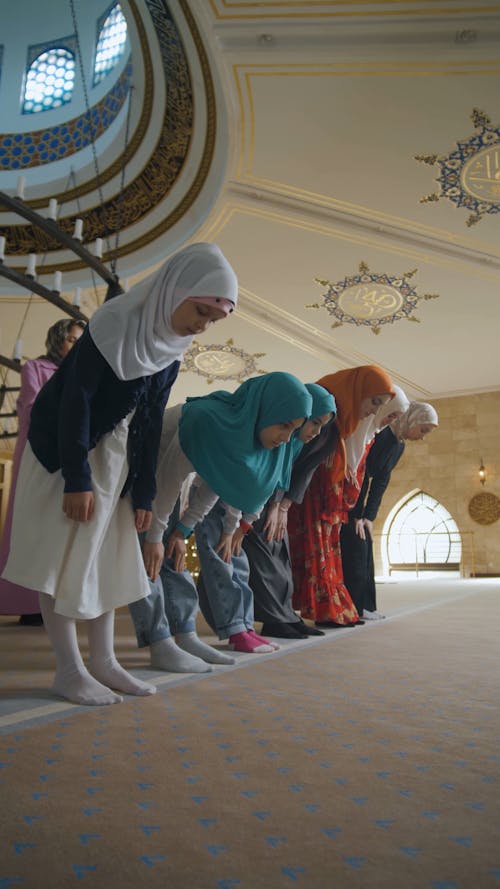 People Bowing Down and Kneeling while Praying
