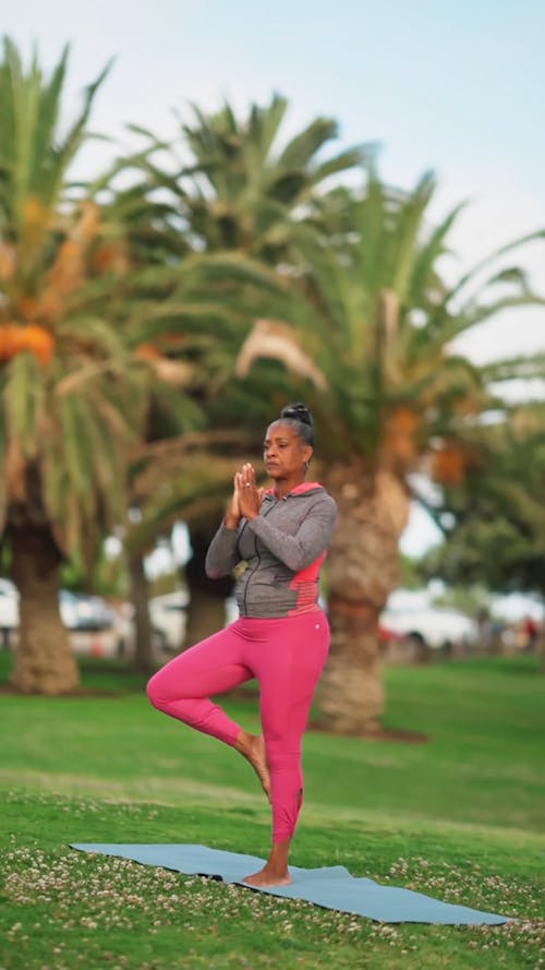 An Elderly Woman Doing Yoga at a Park