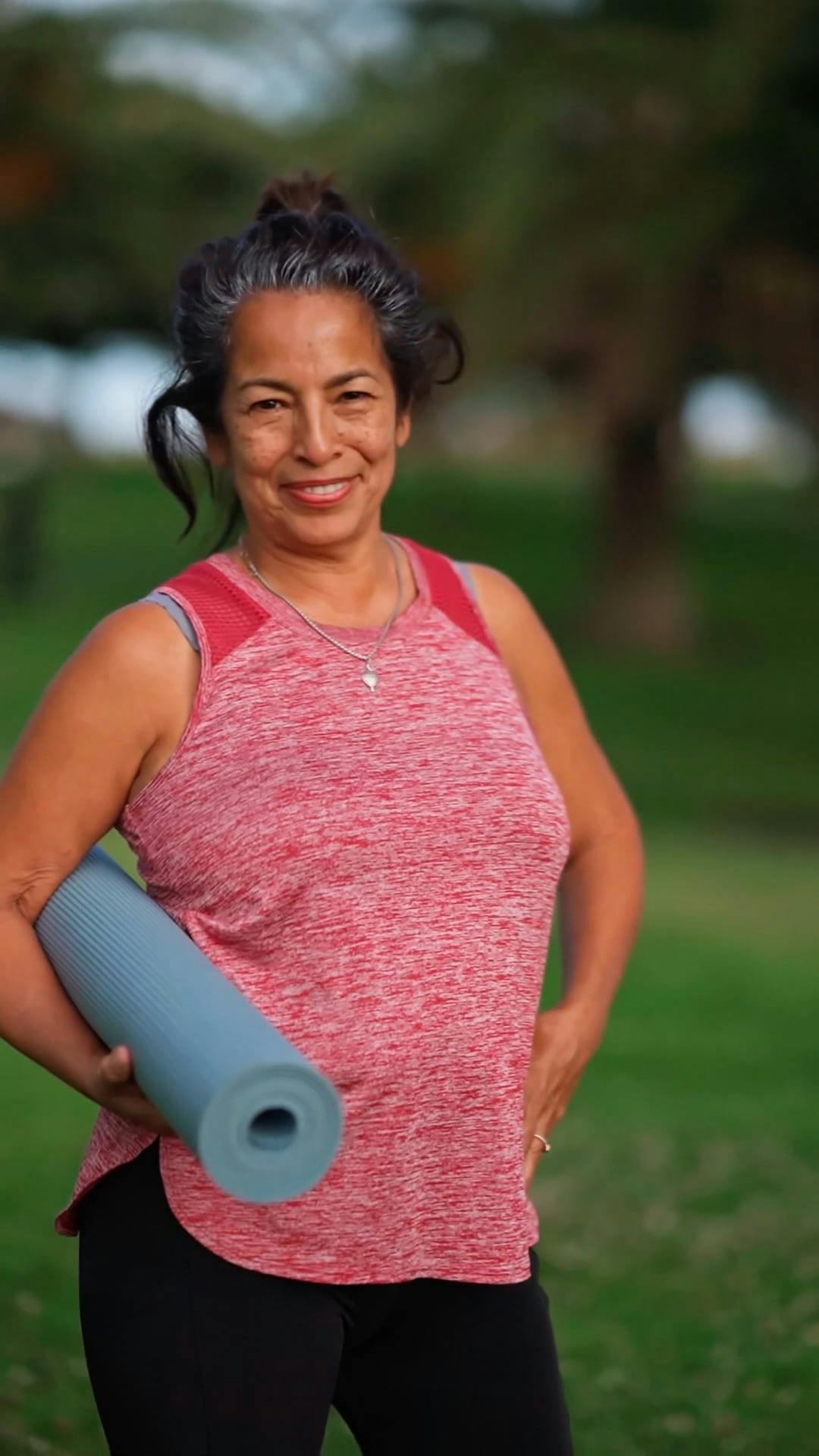 An Elderly Woman Posing while Carrying a Yoga Mat \u00b7 Free Stock Video