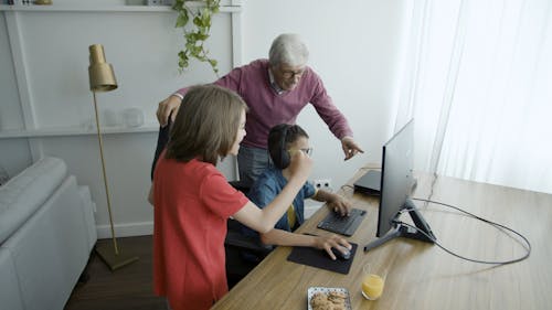 A Little Boy Playing a Video Game on a PC