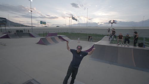 A Man Practicing Skateboarding Tricks in the Skate Park