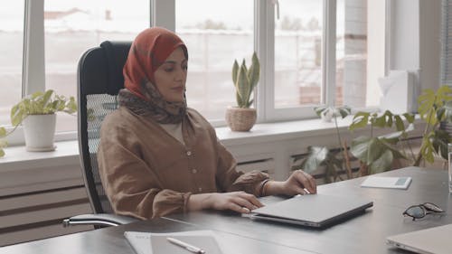 A Woman Using Laptop at Work