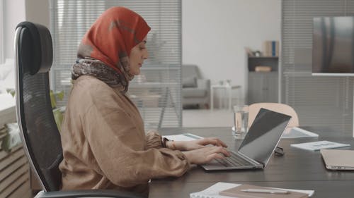 A Woman Using a Laptop at Work