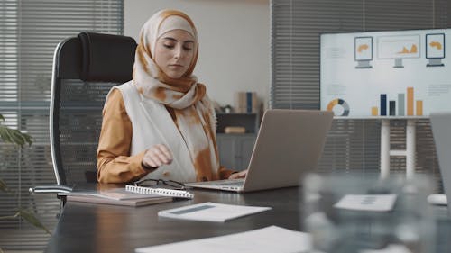 A Woman Using Laptop at Work