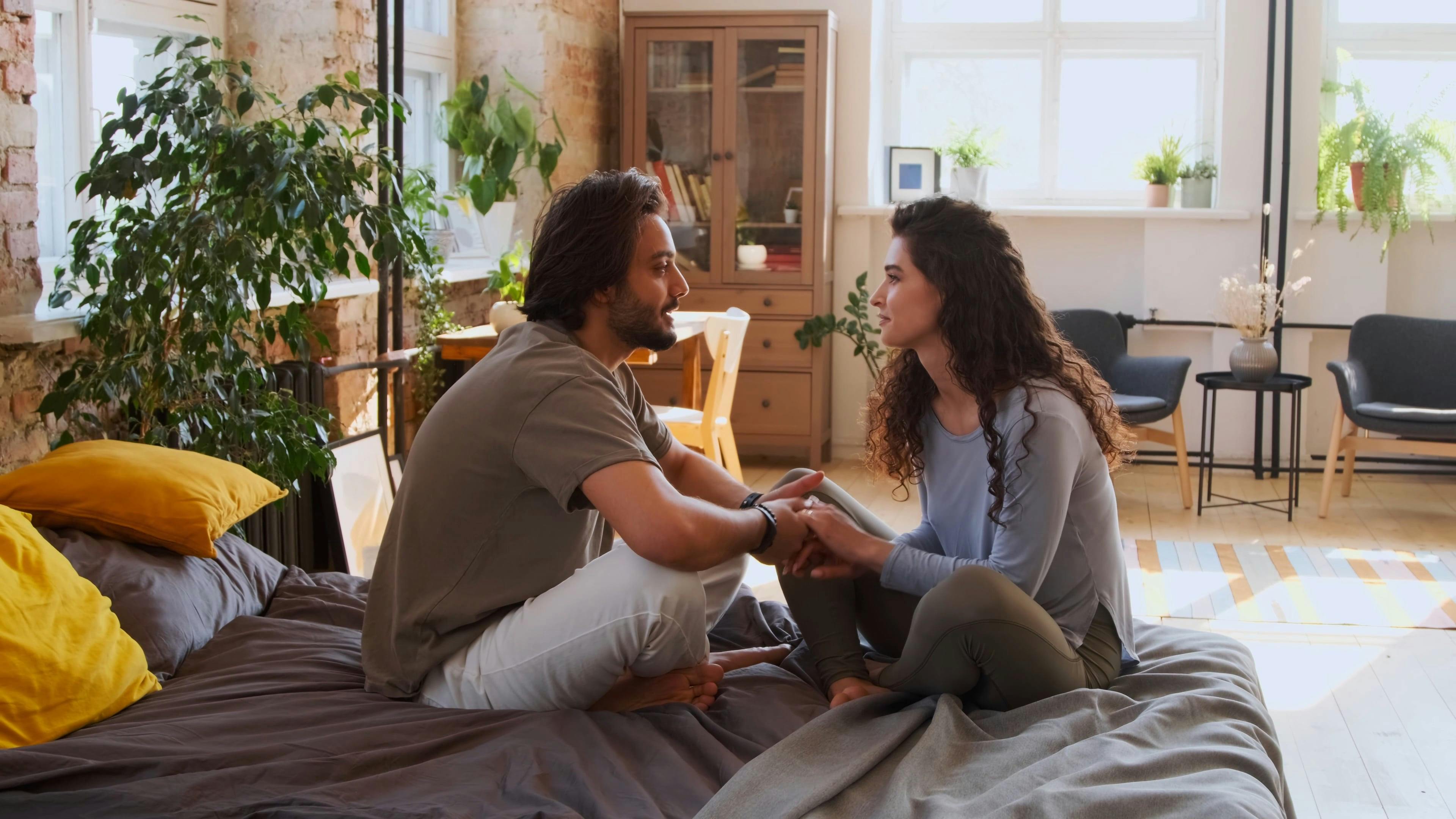 A Couple Sitting on a Bed and Talking · Free Stock Video