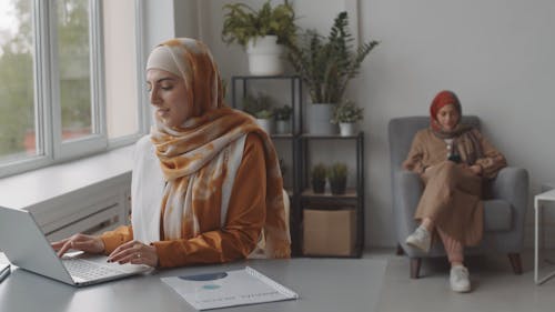 A Woman Using Laptop at Work