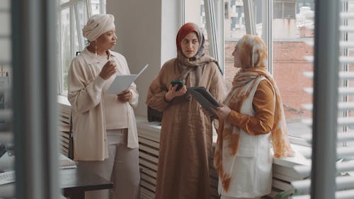 Woman Talking to Her Colleagues