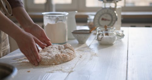 Person Kneading a Dough