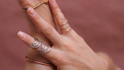 A Close Up of a Woman's Hands with Various Accessories