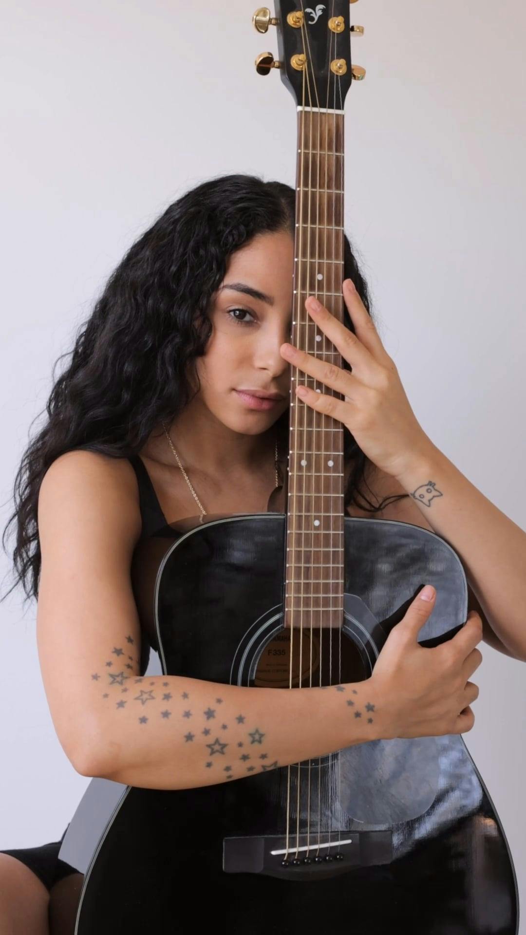 A Woman Holding an Acoustic Guitar · Free Stock Video