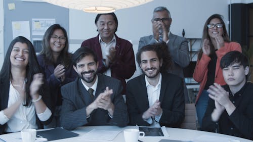 People Applauding In A Business Meeting