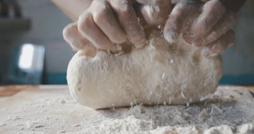 Close Up of a Person Kneading a Dough