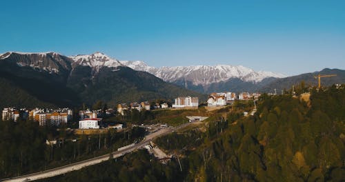 Drone Footage of a Town near Snow Capped Mountains