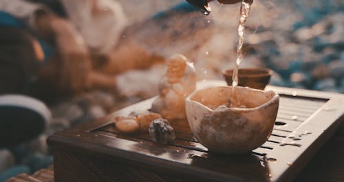 A Woman Pouring a Hot Tea