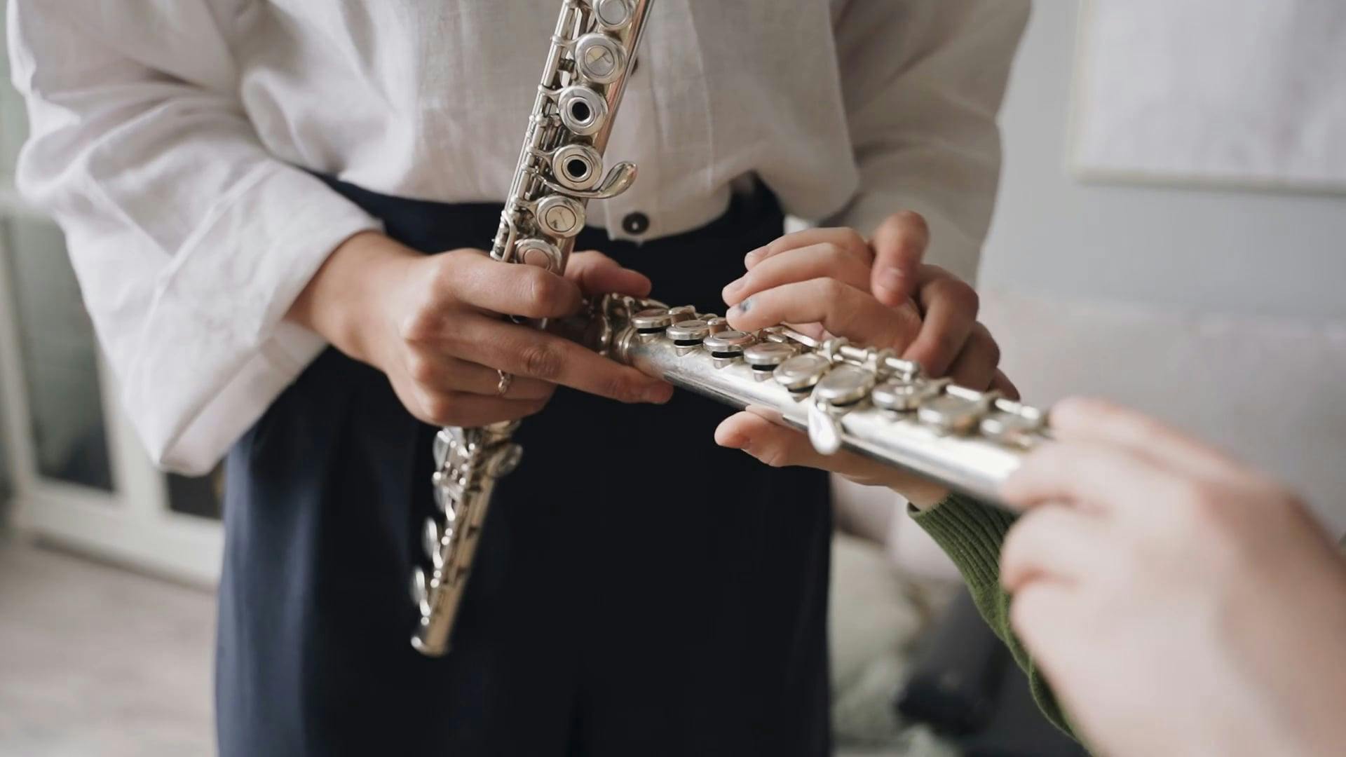 Person Teaching a Boy How to Play the Flute · Free Stock Video