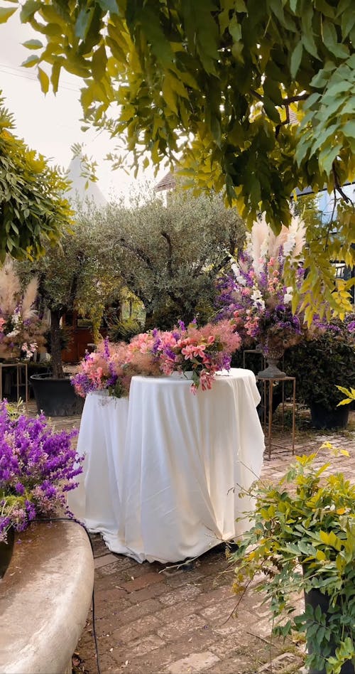 A Water Fountain in the Garden with Flower Decorations