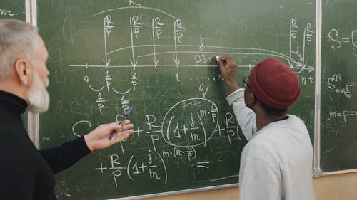 Man Teaching Algebra To A Student