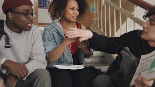 A Smiling Group of Friends Doing a Special Handshake 